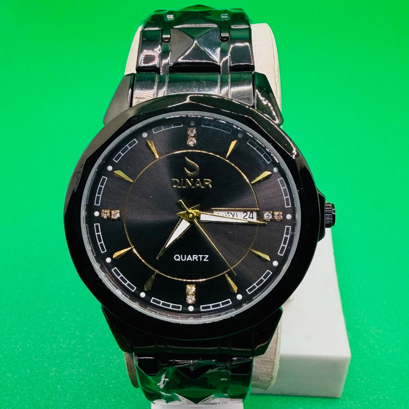 Black and silver watch on a green background