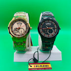 Two ornate IRADD 8083 watch on a stand with an IRADD tag against a green background