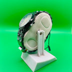 IRADD Watch 8038 on a white stand against a green background