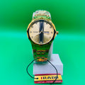 Gold watch on a green background with an IRAD brand tag.
