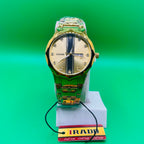 Gold watch on a green background with an IRAD brand tag.