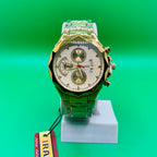 Luxury watch IRADD 8115 with green and gold design on a stand against a green background