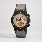 Luxury watch with black case, gray strap, and beige dial on a light gray background